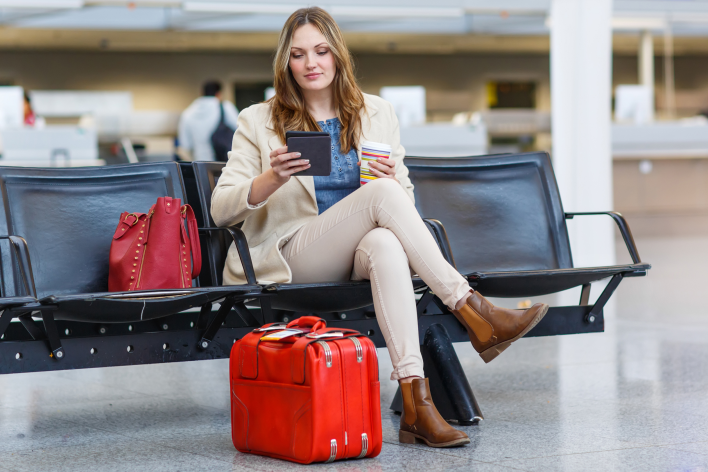 Lady siting on a bench at the airport