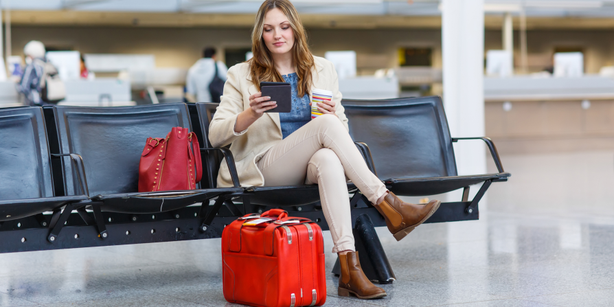 Lady siting on a bench at the airport